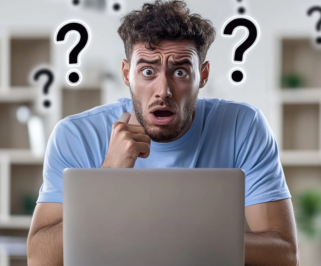 confused man looking at computer